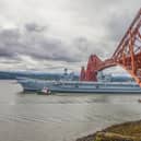 HMS Queen Elizabeth passes under the Forth Bridge as she heads back to sea following lengthy time at Rosyth for repairs and upgrades due to mechanical fault.   (Pic: Katielee Arrowsmith/SWNS)