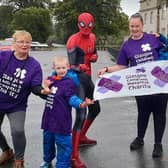 Spider Man joins Jack and his family at the end of their very damp fundraising 5K walk