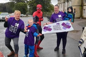 Spider Man joins Jack and his family at the end of their very damp fundraising 5K walk