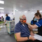 Robert Williams, 84, receives a vaccine at one of the seven mass vaccination centres already opened in England.