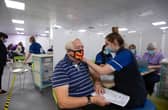 Robert Williams, 84, receives a vaccine at one of the seven mass vaccination centres already opened in England.