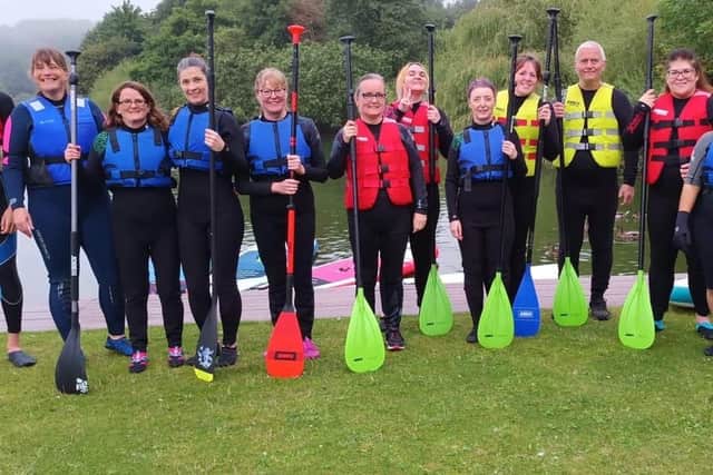 Members of Forth Valley Sensory Centre's Talk and Sign group take to the water for some paddle boarding