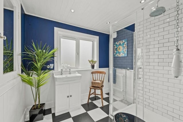 A splash of dark blue helps give this pretty shower room the wow factor.