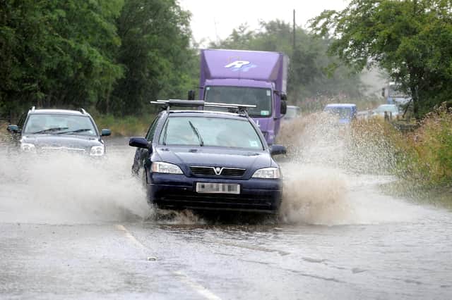 Stock photo of Lisa McPhillips, of heavy rain causing part of the A803 to Linlithgow to flood.