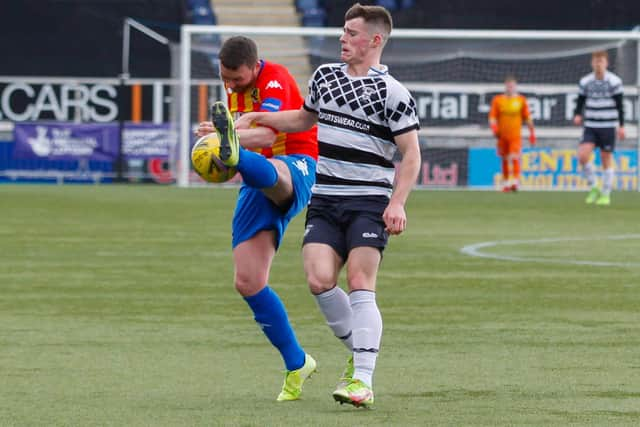 Kieran Offord looks to win the ball back in midfield