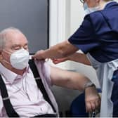 Ian Cormack receives the Oxford/AstraZeneca coronavirus vaccine, administered by practice nurse Ruth Davies, at Pentlands Medical Centre in Edinburgh (Picture: Russell Cheyne/PA)