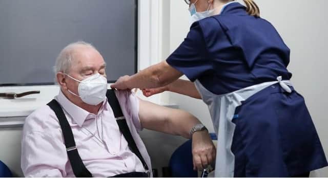 Ian Cormack receives the Oxford/AstraZeneca coronavirus vaccine, administered by practice nurse Ruth Davies, at Pentlands Medical Centre in Edinburgh (Picture: Russell Cheyne/PA)