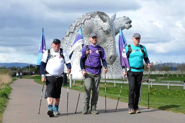 Three dads walking in 2024 pass by The Kelpies, left to right Andy Airey, Tim Owen and Mike Palmer. Pic: Michael Gillen