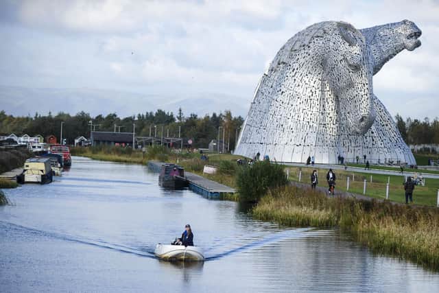 Scottish Canals activities assistant Rebecca Brown aboard one of its electric boats on the Forth & Clyde Canal at the Kelpies. Pic: Lisa Ferguson