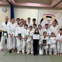 Jayne Clason shares her coaching award with Deanburn Judo Club members