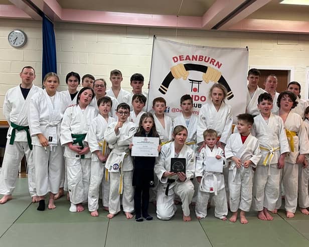 Jayne Clason shares her coaching award with Deanburn Judo Club members