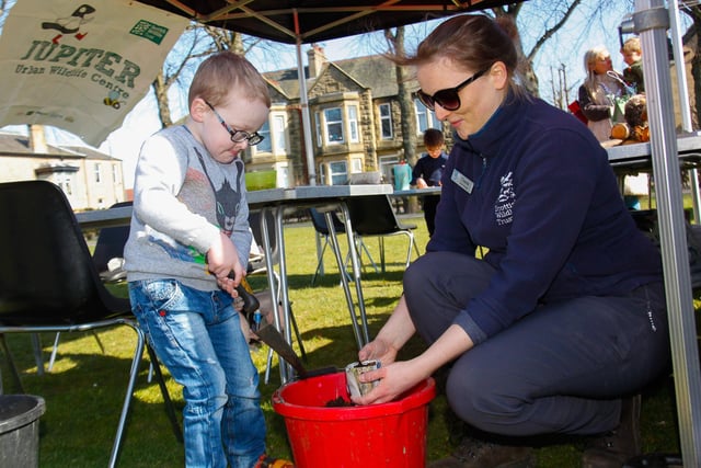 Claire, from the Scottish Wildlife Trust, planting some seeds with Aiden, aged 5, from Grangemouth.