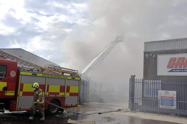 Firefighters tackle  a blaze in scrap yard at Angus Braidwood and Son Ltd on Castle Drive, Falkirk. (Pic: Michael Gillen)