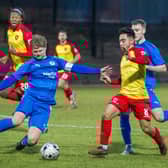 Bo'ness United defender Michael Travis goes in for tackle up against Albion Rovers' Dom McMahon (Photo: Ciaran Reid)