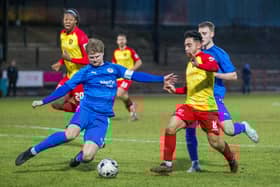 Bo'ness United defender Michael Travis goes in for tackle up against Albion Rovers' Dom McMahon (Photo: Ciaran Reid)