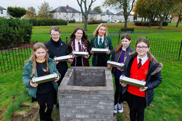 Pictured with the capsules at cairn, left to right Freya McQueen (Bainsford PS), Mary Irvine (Bainsford War Memorial Association), Tamsin Gold (Falkirk High), Eve Harkins (St Mungo's), Karolina Sobina (St Francis PS), and Ruby Johnston (Langlees PS). Pic: Mark Ferguson