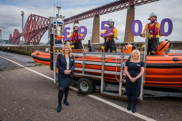 Taylor Wimpey East Scotland sales executives Jacqui Bryson Elder and Helen Allenby with members of the RNLI Queensferry crew. Photo - Chris Watt.