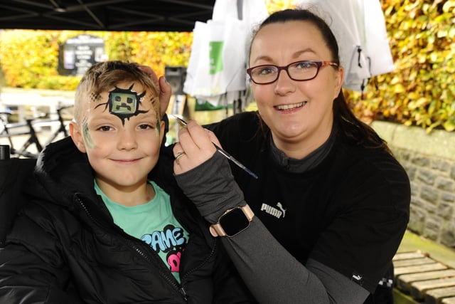 Jason Marshall (6) gets his face painted by Louisa Nimmo.