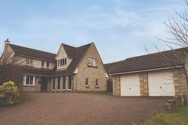 Front of property with driveway and double garage.