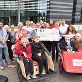 Representatives from Cycling Without Age Scotland receive a £1000 donation from INEOS staff who took part in a Tour De France challenge. (Pic: submitted)