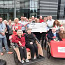 Representatives from Cycling Without Age Scotland receive a £1000 donation from INEOS staff who took part in a Tour De France challenge. (Pic: submitted)