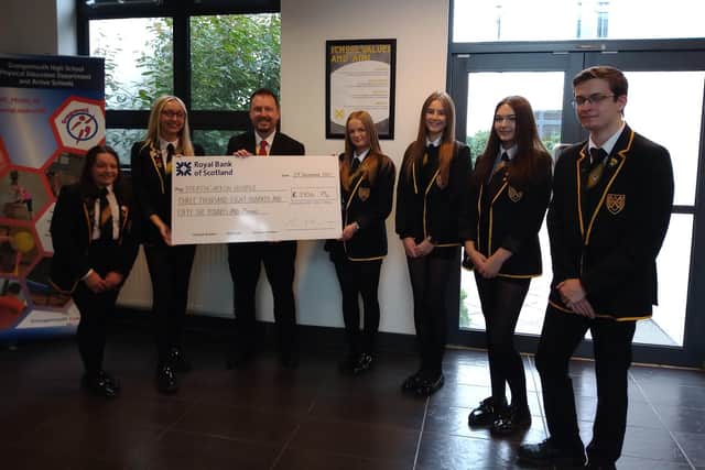 Grangemouth High School pupils Sophie Morrison and Hollie Anderson pictured with depute headteacher Ash Wood and the new school captains Abby Laurie, Lucy Morrison, Ciara Mulhall and Fred Wilson. Picture: Other 3rd Party.
