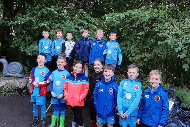 Stenhousemuir FC youngsters take a break from their litter picking at Carron Dams