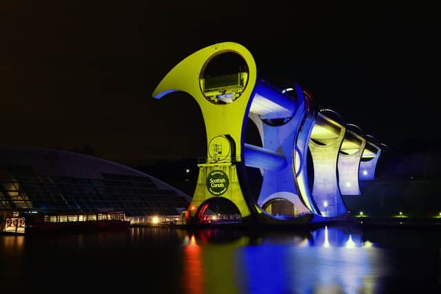The Falkirk Wheel lit up blue and yellow in support of the people of Ukraine. Picture: Michael Gillen
