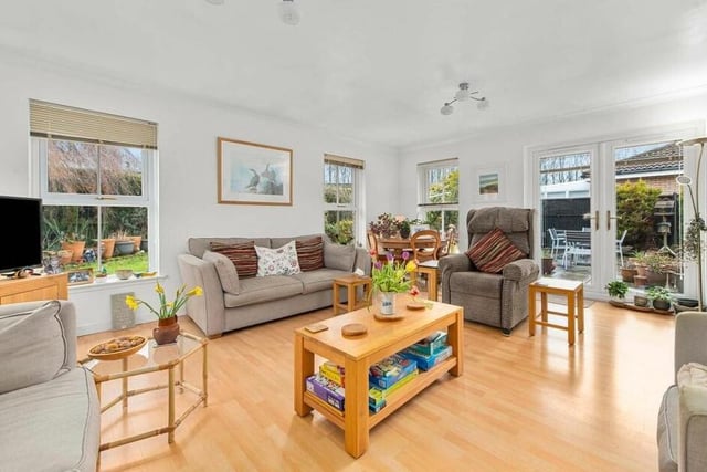Spacious lounge is flooded with light thanks to the picture windows and, with patio doors leading out to the garden, it is also an ideal room for entertaining - indoors and out.