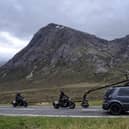 Two stunt workers can be seen racing each other on motorbikes, which appear to be from the World War Two era, behind a vehicle with a large camera rig. Photo: Tony Featherstone / SWNS.COM