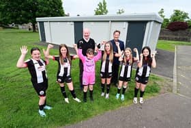 Falkirk Council's Deputy Leader Councillor Paul Garner with council officer William Marshall and players from Dunipace Football Club's under-12s team outside the new pavilion at Tygetshaugh (Bottom Castle Park). Pic: Falkirk Council