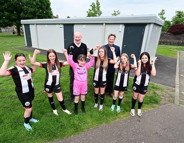 Falkirk Council's Deputy Leader Councillor Paul Garner with council officer William Marshall and players from Dunipace Football Club's under-12s team outside the new pavilion at Tygetshaugh (Bottom Castle Park). Pic: Falkirk Council