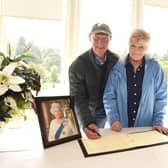 Joyce Dingwall and husband Derek, originally from Grangemouth but now living in South Africa, sign the book of condolence for HM The Queen in Callendar House, Falkirk