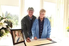 Joyce Dingwall and husband Derek, originally from Grangemouth but now living in South Africa, sign the book of condolence for HM The Queen in Callendar House, Falkirk