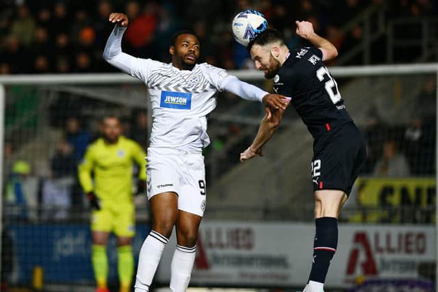 Falkirk centre-half Brad McKay clears a high ball in the Bairns box with Ayr United's Dipo Akinyemi in close attention (Photo: Michael Gillen)