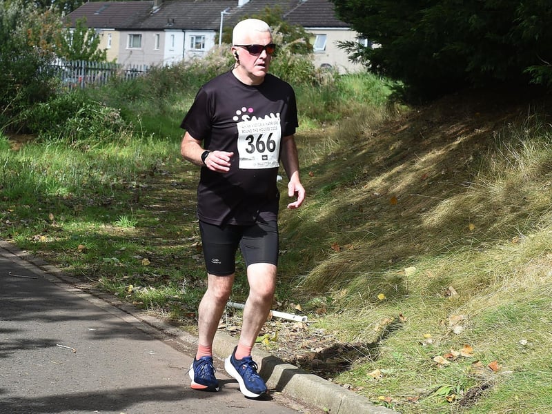 Equipped for the bright sun, this shade sporting runner's race is almost done
