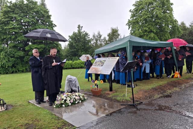 Reverend Andrew Moore with the Strathcarron Singers at a memorial service to mark a paupers' grave in Larbert. Picture: Contributed