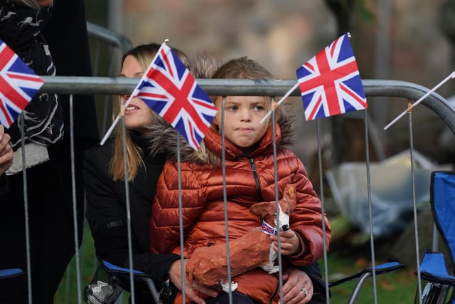 Members of the public line the streets in Ballater ahead of the hearse carrying the coffin of Queen Elizabeth passing through the town (Pic: PA/Andrew Milligan)