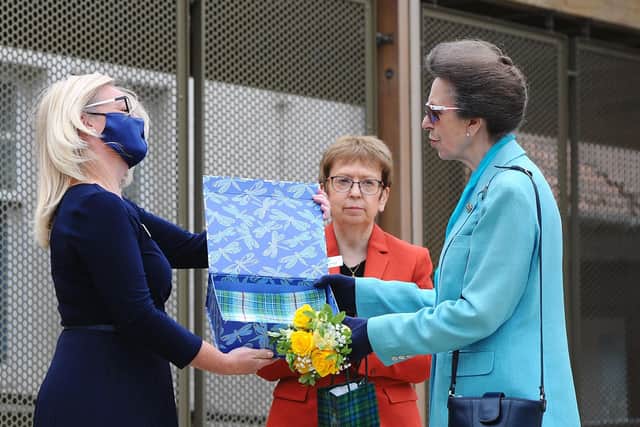 HRH The Princess Royal is presented with a Strathcarron snowdrop tartan scarf designed to mark the hospice 40th anniversary