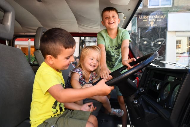 These youngsters are happy to get inside this fire appliance