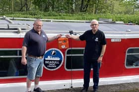 St John Scotland area chairman Derek Watson hands over two defibrillators to John Sime of the Seagull Trust. Pic: Contributed