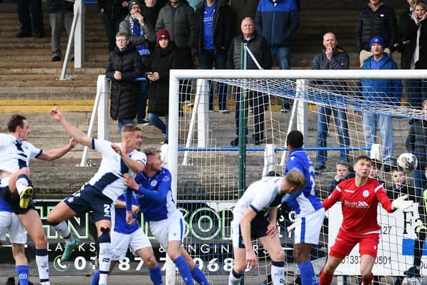 Tom Lang heads in the opener for Falkirk at Queen of the South (Pics by Michael Gillen)