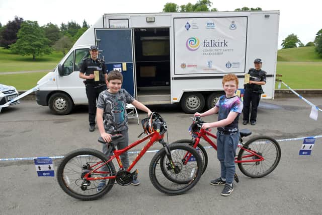 Falkirk community officers PC Michael Ritchie and PC Ashley Mylchreest with Magnus Cooper (10) and Harris Cooper (8), from Falkirk, at the bike marking event at Callendar House. Picture: Michael Gillen.