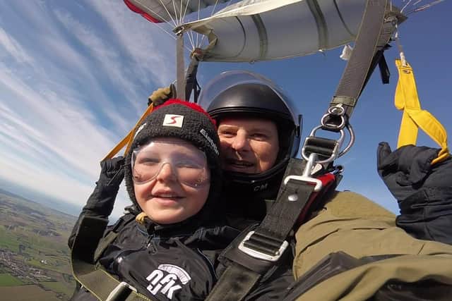 Tyler was all smiles as the parachute opened and he and his instructor floated back down to earth!