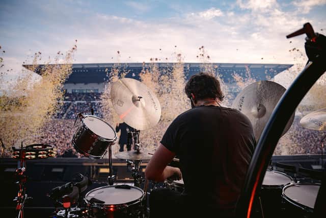Drummer Ronnie Vannucci almost hidden by a confetti cloud