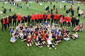 Youngsters pose with Stenhousemuir FC's first team squad - who joined in the fun and helped run training drills