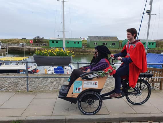 Student Andrew Byrne-King pilots new Rector Dr Leyla Hussein OBE on her 'drag' around St Andrews.