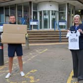 Cecil Meiklejohn accepting a donation of Falkirk FC football strips for kids attending the primary school hubs from Kieran Koszary, Falkirk FC. Picture Michael Gillen.