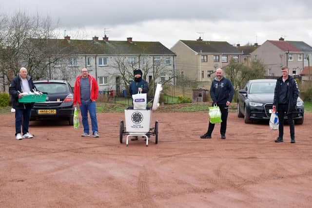 Various organisations have come together to support Camelon Community Hub (CCH). From left: Peter Cunningham, volunteer; Gary Clark, of CCH; Craig Stirling, TCV Conservation volunteer using delivery bike loaned from Falkirk Travel Hub; Iain Goodall, of CCH; and Calum Heeps, Camelon Juniors' director of football. Picture: Michael Gillen.