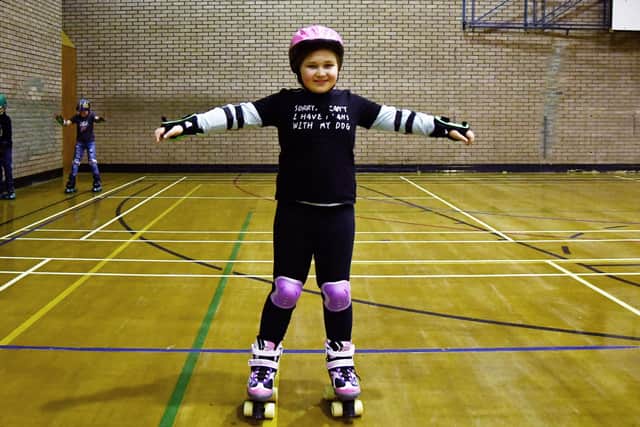 Young Carers Group, including Isabella, 10, taking part in roller disco at Bo'ness Recreation Centre